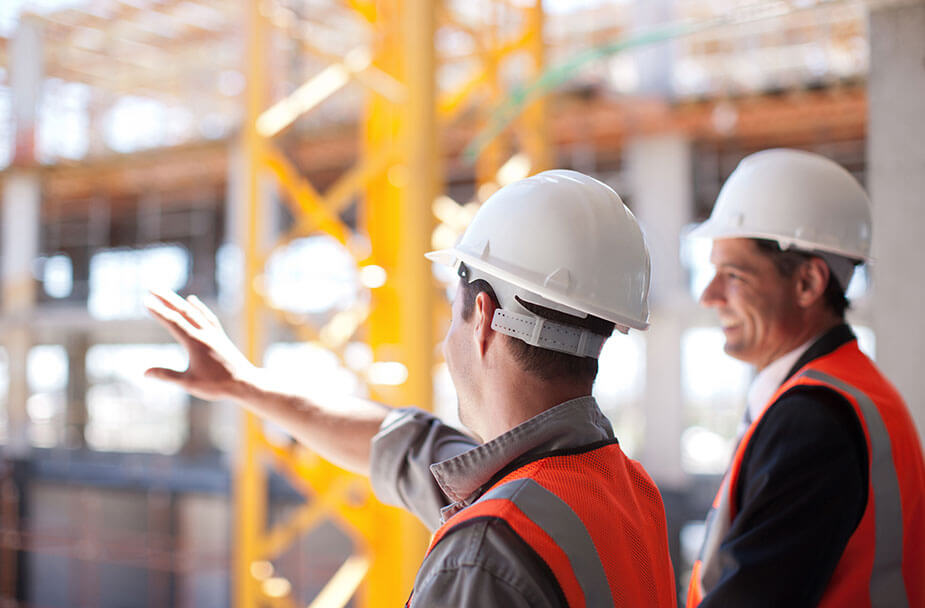 Two construction workers from the staffing agency Superior Skilled Trades standing on a construction site.