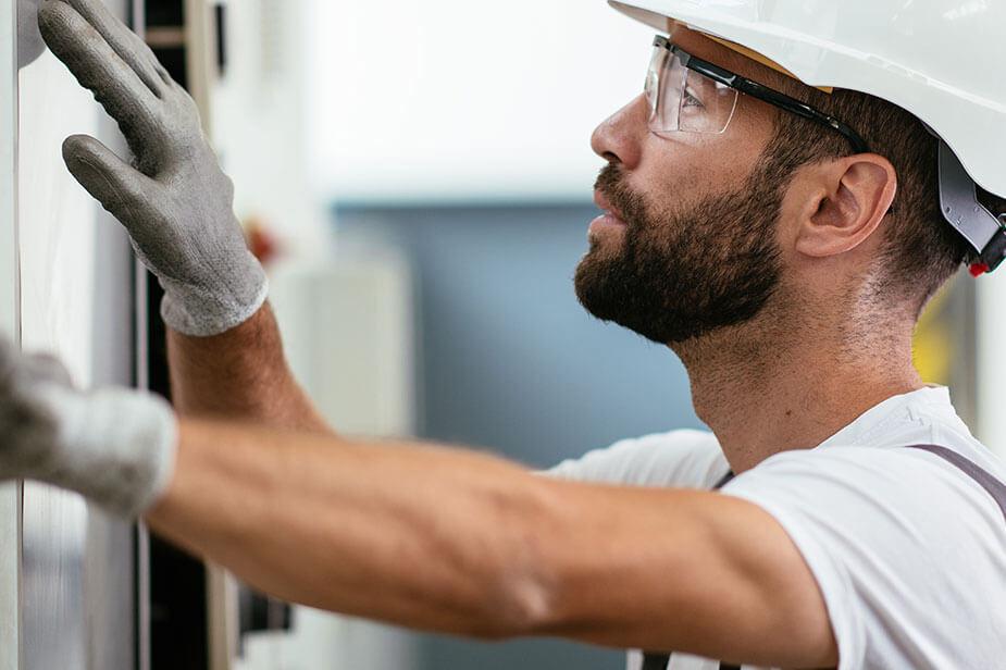 A Superior Skilled Trade high-voltage substation employee performing his job.